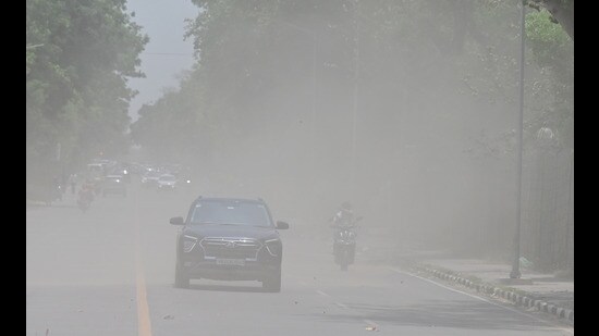 Commuters going through the dust storm in Chandigarh on Friday. (Ravi Kumar/ HT)