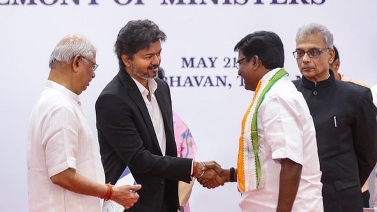 Tamil Nadu Governor Rajendra Vishwanath Arlekar and Chief Minister C Joseph Vijay congratulate Congress leader P Viswanathan, who took oath of office as Higher Education Minister, during the swearing-in ceremony (PTI)