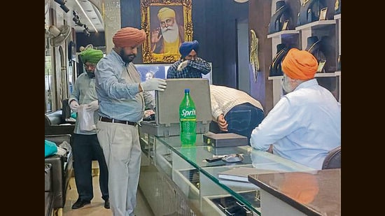 Police during investigation at the jewellery shop at ATI Road in Ludhiana on Friday. (HT Photo)