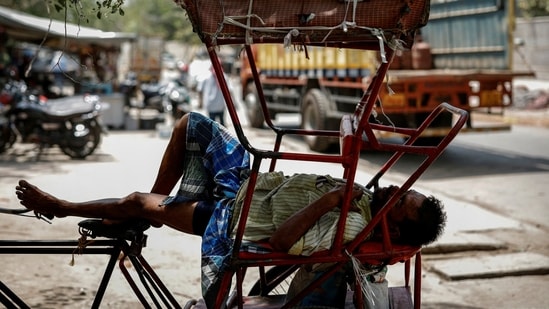 File image: A man sleeps in his rickshaw during a heatwave on a hot summer day in New Delhi