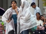 Women cover themselves with an umbrella to protect themselves from heatwave, in New Delhi on Wednesday. Women cover themselves with an umbrella to protect themselves from heatwave, in New Delhi on Wednesday.