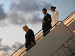 US President Donald Trump, followed by Donald Trump Jr. and Bettina Anderson step off Air Force One upon arrival at Palm Beach International Airport in West Palm Beach, Florida.
