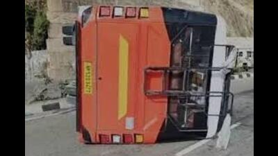 Two persons, including the driver, were injured when a private bus overturned on the Kalka-Shimla National Highway near Salogra in Solan district on Saturday.
