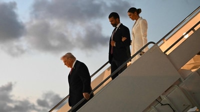 U.S. President Donald Trump, Donald Trump Jr. and Bettina Anderson step off Air Force One after arriving at Palm Beach International Airport in West Palm Beach, Florida. (AFP)
