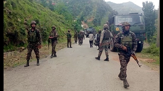Security personnel stand guard during an encounter with the terrorists at Gambhir Muglan, in Rajouri on Saturday. (ANI Video Grab)