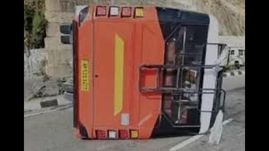 Two persons, including the driver, were injured when a private bus overturned on the Kalka-Shimla National Highway near Salogra in Solan district on Saturday.