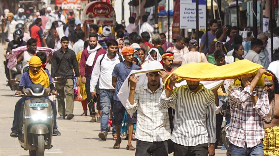 People walk amidst severe heatwave conditions on a hot summer day. (HT_PRINT)