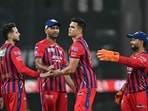 Lucknow Super Giants' Indian cricket player Arjun Tendulkar (2R) celebrates with teammates after taking the wicket of Punjab Kings' Indian cricket player Prabhsimran Singh 