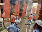Firefighters faced difficulties controlling the blaze due to heavy storage of documents inside the lower court premises. (Parveen Kumar/HT)