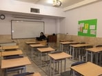 Now only the teacher sits in the empty classroom, voice echoing as she speaks to her pupils by computer. Now only the teacher sits in the empty classroom, voice echoing as she speaks to her pupils by computer.
