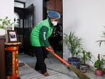 FILE PHOTO: Laxmi, an employee with Pronto cleans a house with a broom in New Delhi, India, March 23, 2026. REUTERS/Bhawika Chhabra/File Photo