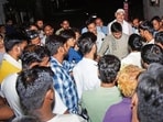 People surround a junior engineer in Lucknow. (HT Photo) People surround a junior engineer in Lucknow. (HT Photo)
