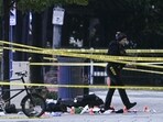 Police tape blocks off a crime scene with evidence markers seen on a sidewalk on 17th and Pennsylvania Ave near the White House in Washington, DC.
