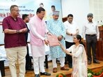 Uttarakhand Chief Minister Pushkar Singh Dhami distributes appointment letters to candidates selected for irrigation and agriculture department posts at an event in Dehradun on Friday.