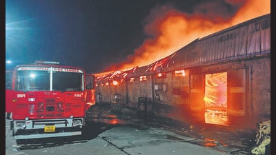 A fire engine at the cotton warehouse in Lehli area of Lalru in the wee hours of Sunday. (HT Photo)