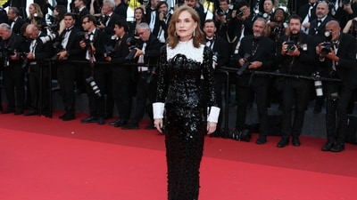 French actor Isabelle Huppert embraced timeless Parisian chic in a sparkling black sequinned gown featuring crisp white collar and cuff details. (AFP)