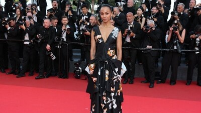 US actor Zoe Saldana brought playful elegance in a dramatic black floral gown featuring oversized sculptural bow detailing at the waist.&nbsp; (AFP)