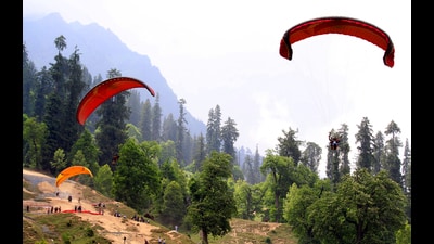 Tourists enjoying paragliding over the Solang valley on Sunday. (Aqil Khan /HT)