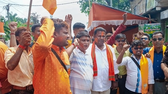 BJP supporters celebrate outside a counting centre, at Falta, in South 24 Parganas district, West Bengal.