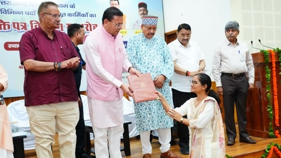 Uttarakhand Chief Minister Pushkar Singh Dhami distributes appointment letters to candidates selected for irrigation and agriculture department posts at an event in Dehradun on Friday.
