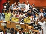 AAP councillors were seen holding placards demanding the resignation of union education minister Dharmendra Prasad. (Arvind Yadav/HT Photo)