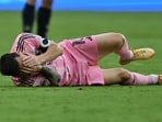 Lionel Messi falls after colliding with Geiner Martinez during an MLS match.