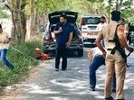 Police and forensic teams investigate the crime scene after ASI Joga Singh was shot dead by unidentified assailants on the Majitha-Fatehgarh Churian road in Amritsar on Sunday. (HT Photo)