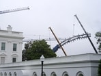 Cranes work on the UFC fighting ring and lighting for an upcoming event near the White House, on Memorial Day, Monday, May 25.