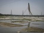 A view of the dried bed of the Yamuna River due to extreme heat conditions at Wazirabad in New Delhi, India, on Sunday,