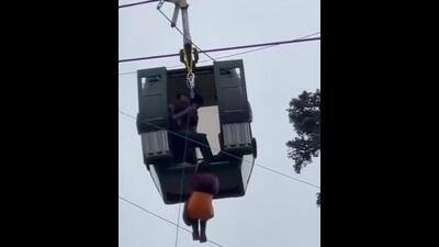 A video grab of a passenger being rescued from the Gulmarg cable car system after it developed a snag on Monday afternoon. A video grab of a passenger being rescued from the Gulmarg cable car system after it developed a snag on Monday afternoon.