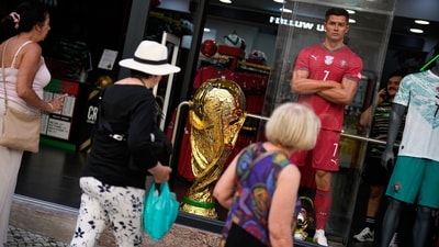 A enlarged replica of the FIFA World Cup trophy is displayed in a shop window next to a mannequin resembling Portugal soccer team captain Cristiano Ronaldo (AP Photo/Armando Franca) A enlarged replica of the FIFA World Cup trophy is displayed in a shop window next to a mannequin resembling Portugal soccer team captain Cristiano Ronaldo (AP Photo/Armando Franca)