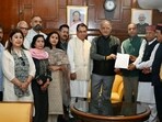 BJP’s Jai Ram Thakur (centre) hands over a memorandum to governor Kavinder Gupta in Shimla on Monday. (Deepak Sansta/HT)