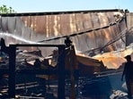 Firefighter trying to control fire broke out in Ganpati Timber in Ludhiana on Tuesday. (Gurpreet Singh/HT)
