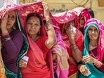 Women shield themselves from the scorching heat on a hot summer day in Rishikesh on Monday.(PTI)