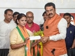 Bihar BJP President Sanjay Saraogi presents a party membership slip to former state Rashtriya Janata Dal (RJD) Women's Wing President Ritu Jaiswal after she joins BJP, in Patna.