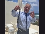 In the footage, Kennedy approaches the snakes and eventually lifts both reptiles off the ground with his hands.