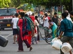 New Delhi, India - May 26, 2026: Residents of Vivekanand Camp in Chanakya Puri rush to fill empty utensils as water tank arrives on a hot summer afternoon, in New Delhi, India, on Tuesday, May 26, 2026. New Delhi, India - May 26, 2026: Residents of Vivekanand Camp in Chanakya Puri rush to fill empty utensils as water tank arrives on a hot summer afternoon, in New Delhi, India, on Tuesday, May 26, 2026.
