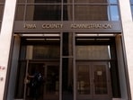 A man walks into the Pima County Administrator’s Building on the day of a discussion regarding concerns related to Sheriff Chris Nanos' work history, including the Nancy Guthrie case, management of the Pima County Sheriff's Department and interaction with federal immigration officials, during a Pima County Board of Supervisors meeting, in Tucson, U.S., May 12, 2026.  REUTERS/Rebecca Noble