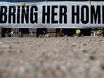 TUCSON, ARIZONA - MARCH 03: Candles and flowers are placed at a Nanthy Guthrie memorial in front of the KVOA news station on March 03, 2026 in Tucson, Arizona. (Photo by JUSTIN SULLIVAN / GETTY IMAGES NORTH AMERICA / Getty Images via AFP)