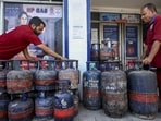 Workers stack LPG cylinders at a gas agency in Jammu. (PTI)
