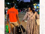 A picture of a shopping assistant holding a woman's bags sparked a debate online