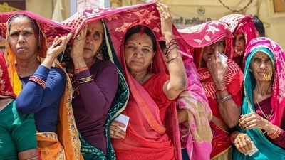 Women shield themselves from the scorching heat on a hot summer day in Rishikesh on Monday. (PTI) Women shield themselves from the scorching heat on a hot summer day in Rishikesh on Monday. (PTI)