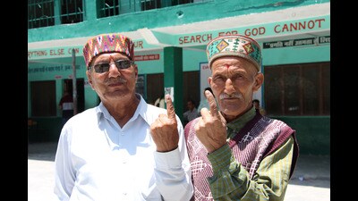 Two elderly voters show their inked fingers during the Kullu panchayati raj elections on Tuesday. (Aqil Khan /HT)