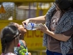 A lady offers water to a child amid scorching heat in New Delhi. (Raj K Raj/HT Photo) A lady offers water to a child amid scorching heat in New Delhi. (Raj K Raj/HT Photo)