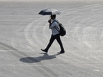 A pedestrian carries an umbrella on a hot summer day as he walks along a street in Chennai on May 27, 2026. (AFP)