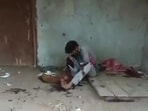 A screengrab from the viral video showing man slitting the canine’s throat (HT Photo)
