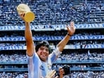 Diego Maradona hoists the FIFA World Cup trophy as he is carried off the field by fans and teammates after the 1986 World Cup. (Getty Images)