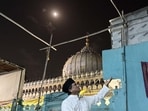 Late this sweltering summer night, Chand Qawwal is sitting with his harmonium in the courtyard of his home, the Dargah’s marble dome looming behind him. (HT Photo)