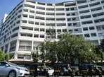 Vehicles drive past in front of Mithibai College, Ville Parle in Mumbai