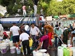Residents of Vivekanand Camp in Chanakyapuri get their supply. (Vipin Kumar/HT Photo)